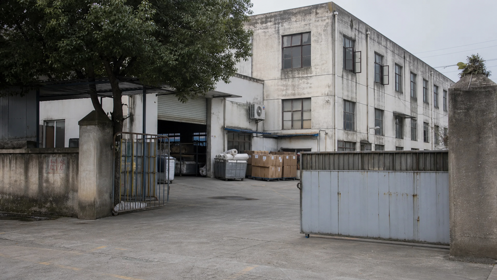 Older curtain factory exterior with fabric carts and cartons