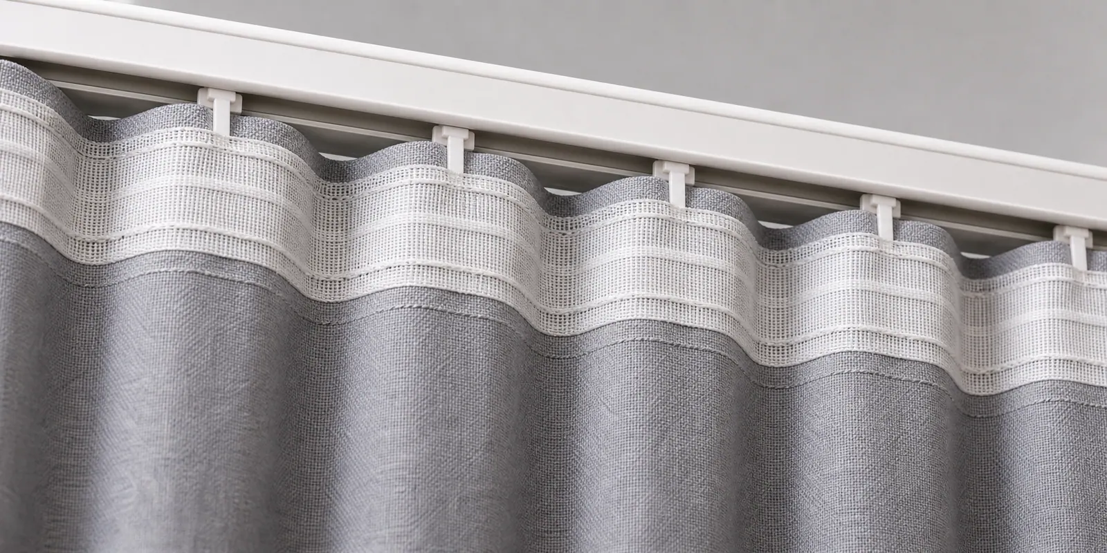 Ripple fold heading tape sewn to gray curtain fabric
